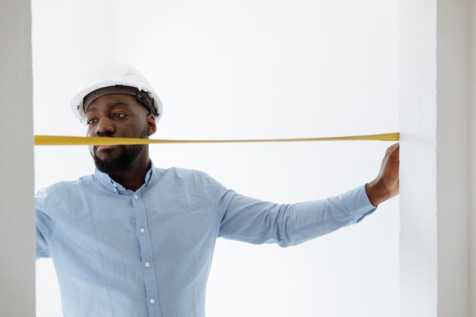 Professional measuring a window frame for double hung windows